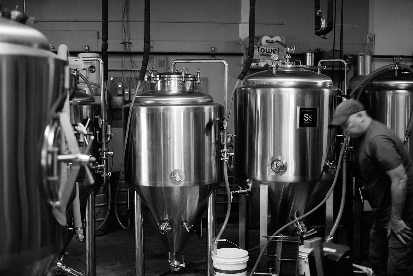 Jake working among the stainless-steel fermentation tanks at The Keg Stand Brewing Co.
